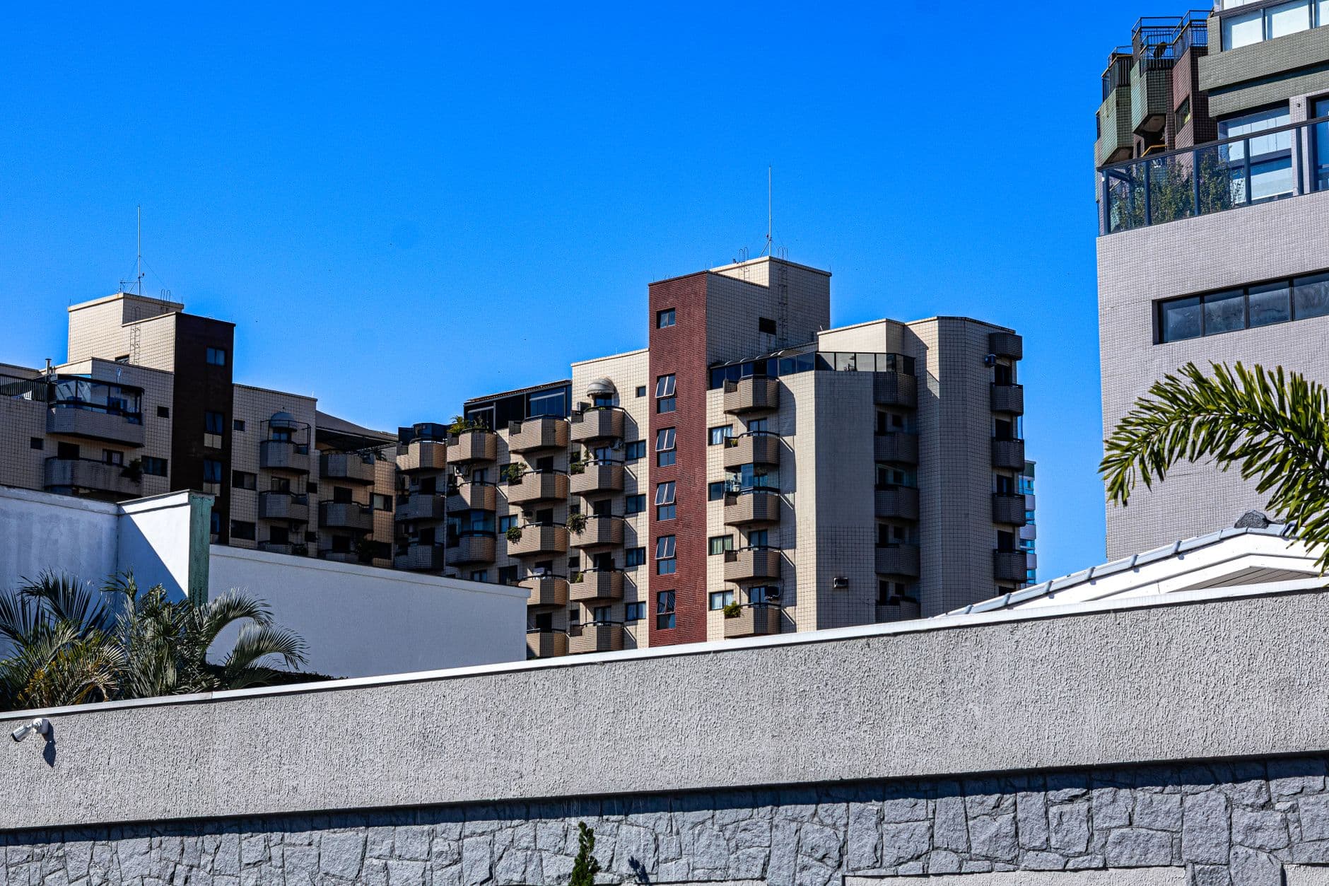 Urban architecture of modern apartments under a clear blue sky in Praia Grande, Brazil.