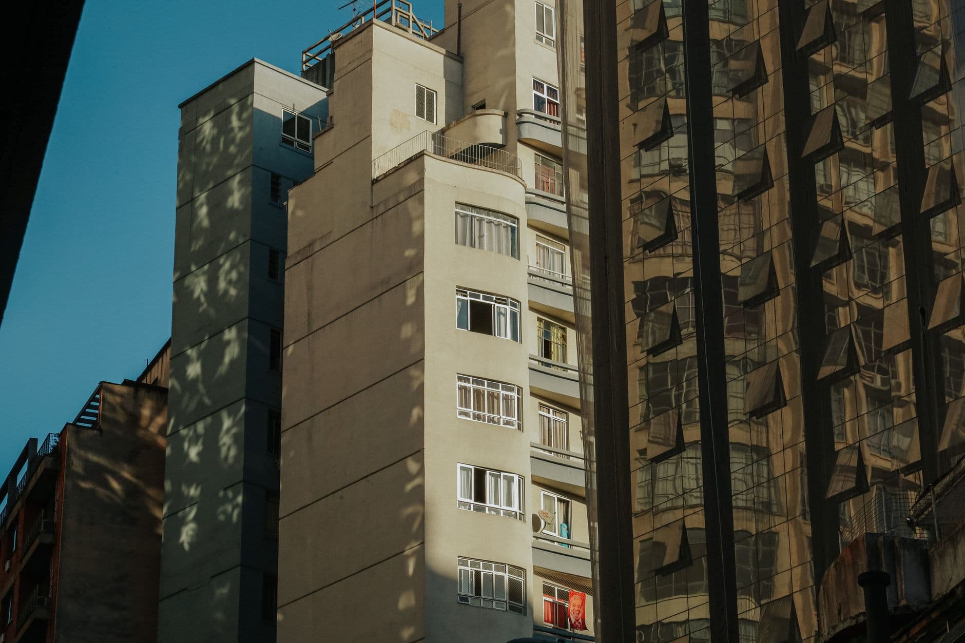 Modern urban architecture reflecting in glass surfaces in downtown Curitiba, Brazil.