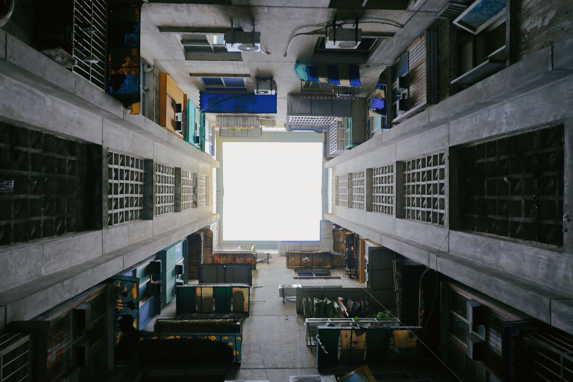 A unique perspective from the bottom of an urban alleyway looking upwards.
