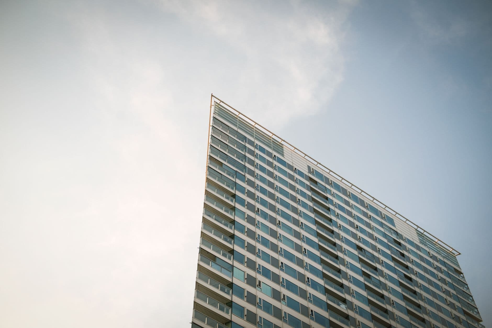 A modern skyscraper in Bratislava, Slovakia under a clear summer sky.