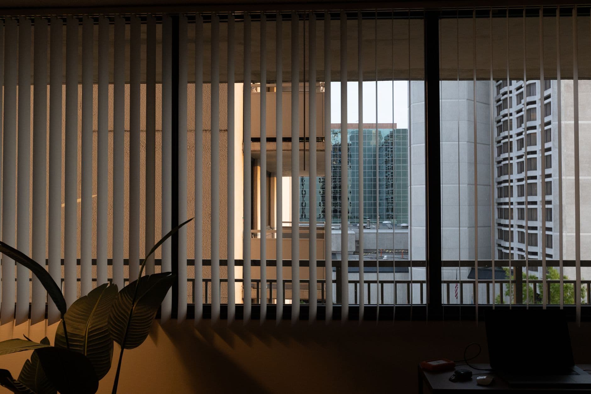A minimalist view through blinds, showcasing urban architecture in Washington DC.
