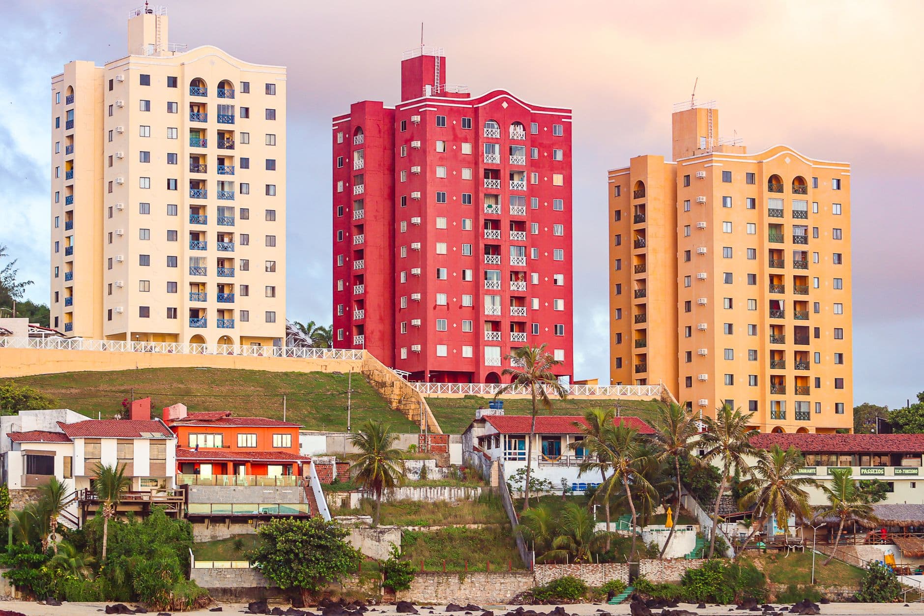 Colorful high-rise buildings overlooking a tropical beach in Natal, Brazil, showcasing urban coastal architecture.