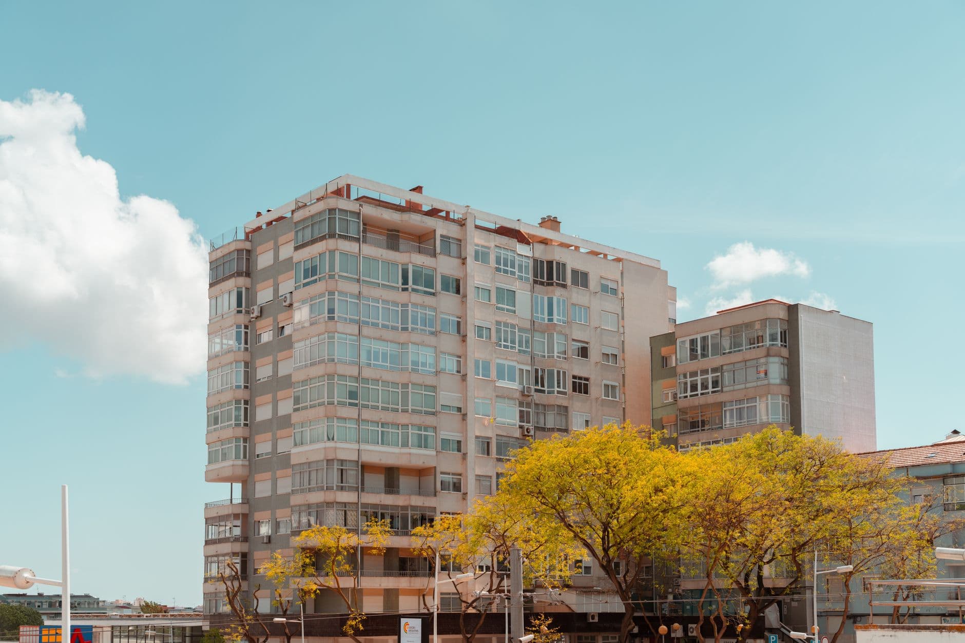 A contemporary high-rise building in Lisbon, Portugal, on a sunny day with clear skies.