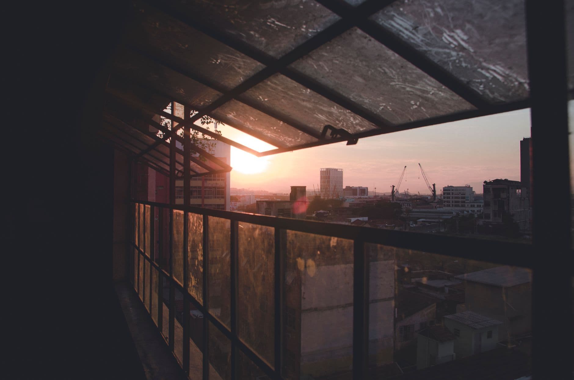 Beautiful sunrise over Rio de Janeiro cityscape viewed through a window, capturing urban serenity.