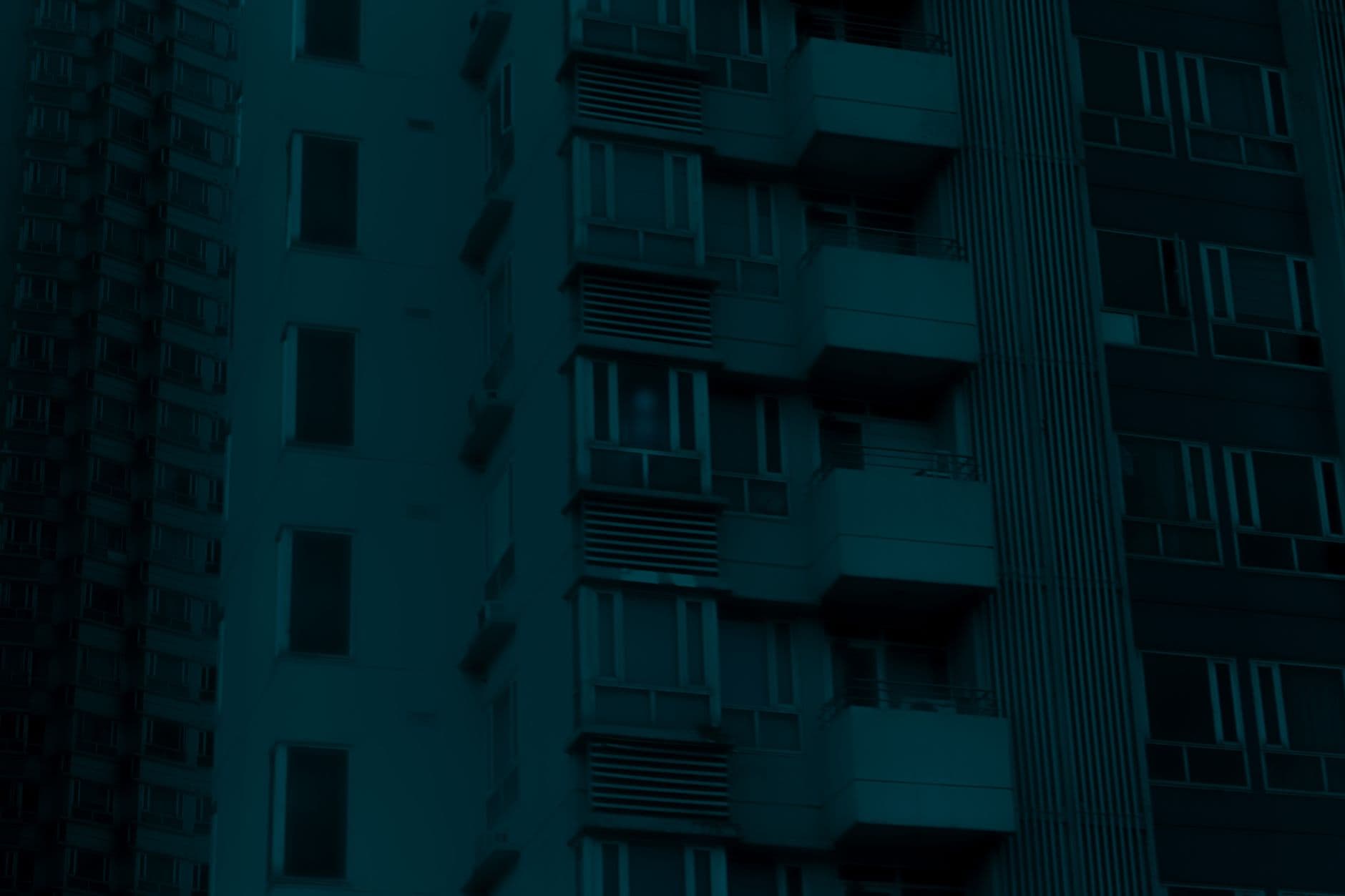 A high-rise residential block at night showcasing urban architecture and city living.