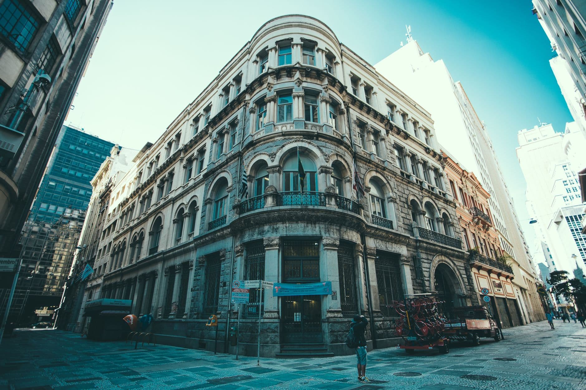 A majestic historic building stands in the heart of a vibrant downtown cityscape.