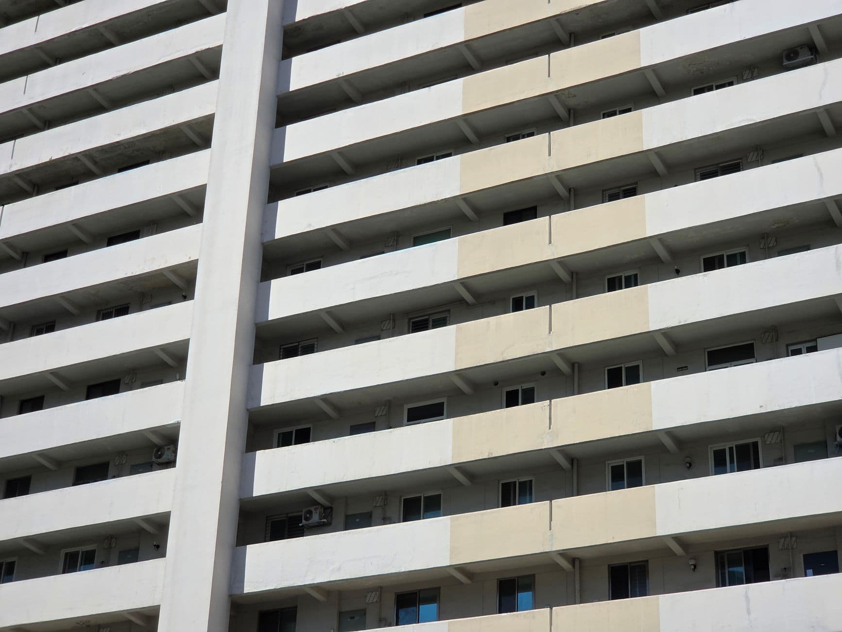 A modern high-rise apartment building facade with balconies in Seoul, South Korea.