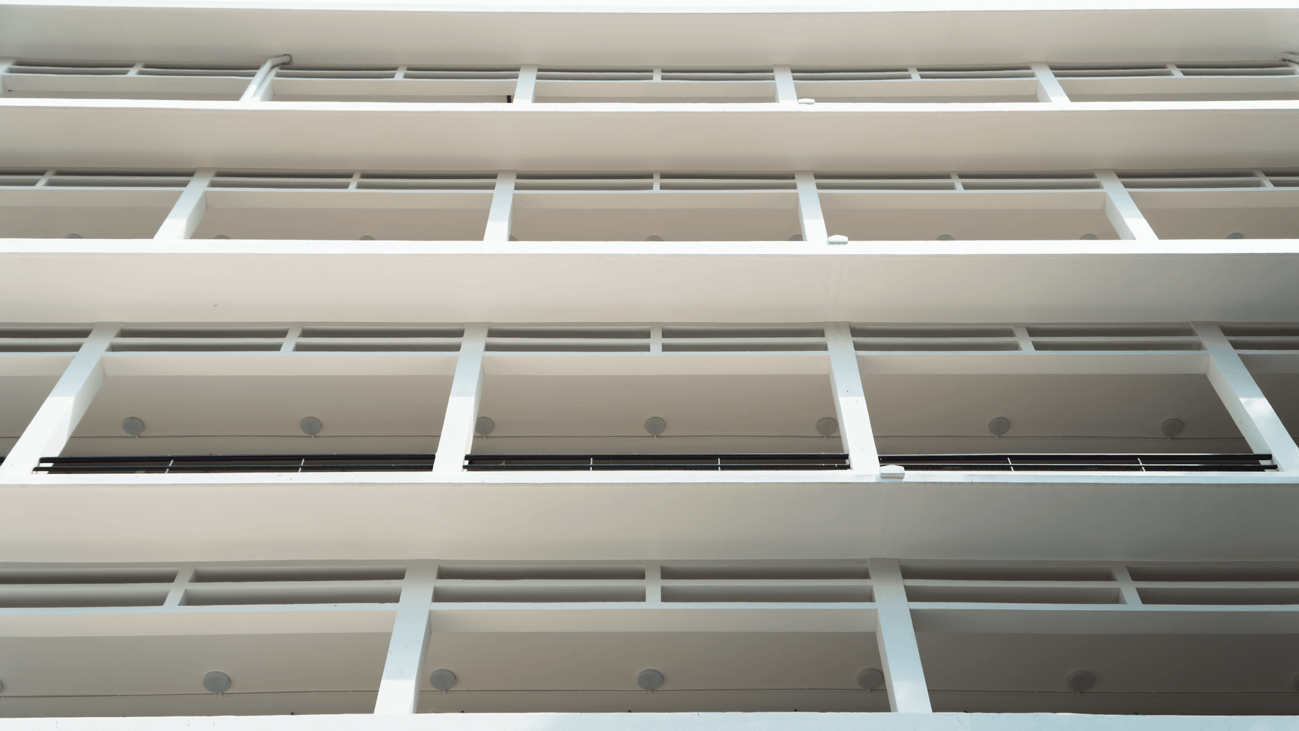 A modern white building showcasing minimalism, clean lines, and repetitive patterns.