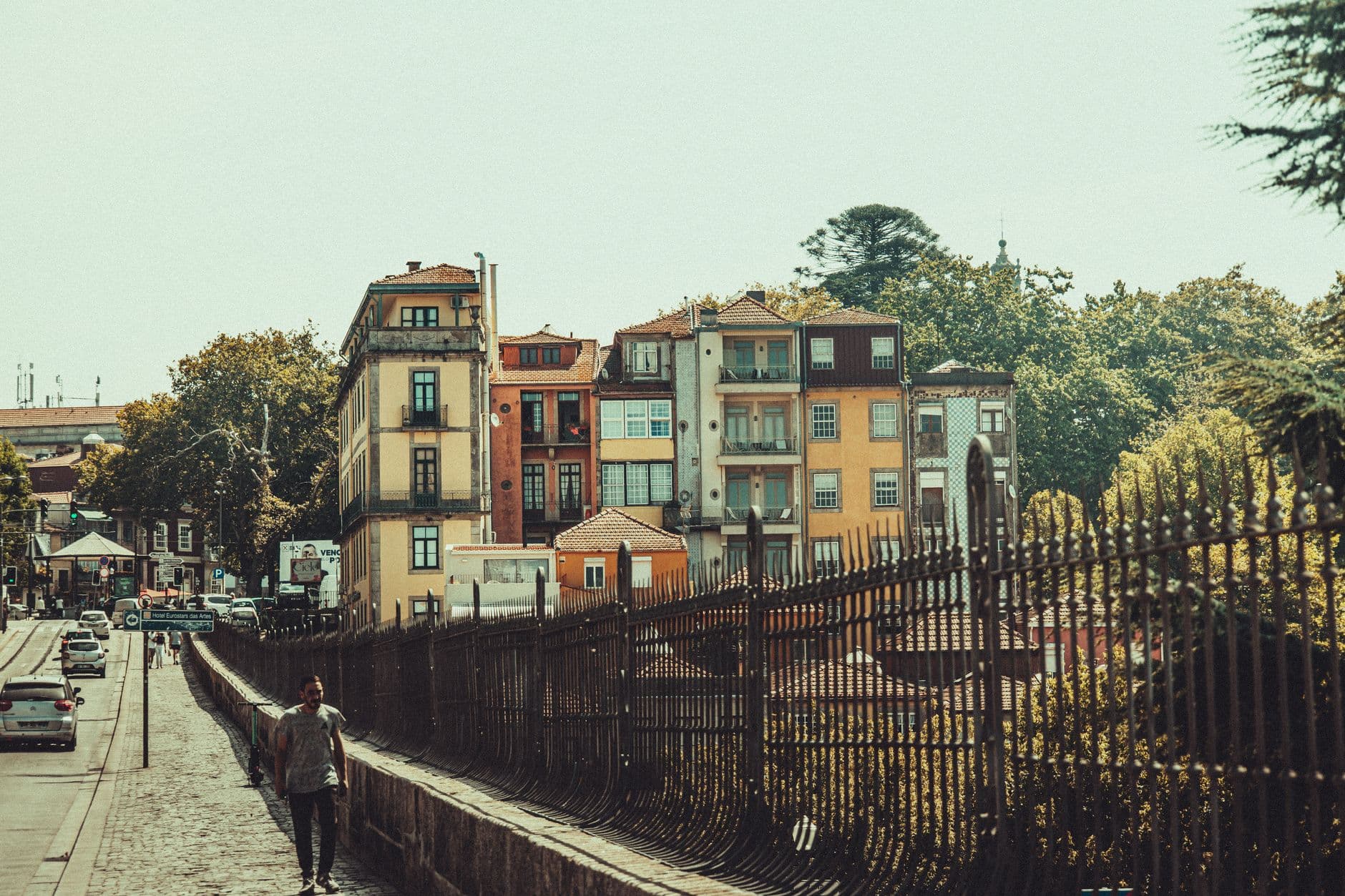 Urban scene with colorful buildings and a street in Porto, Portugal, showcasing city life.