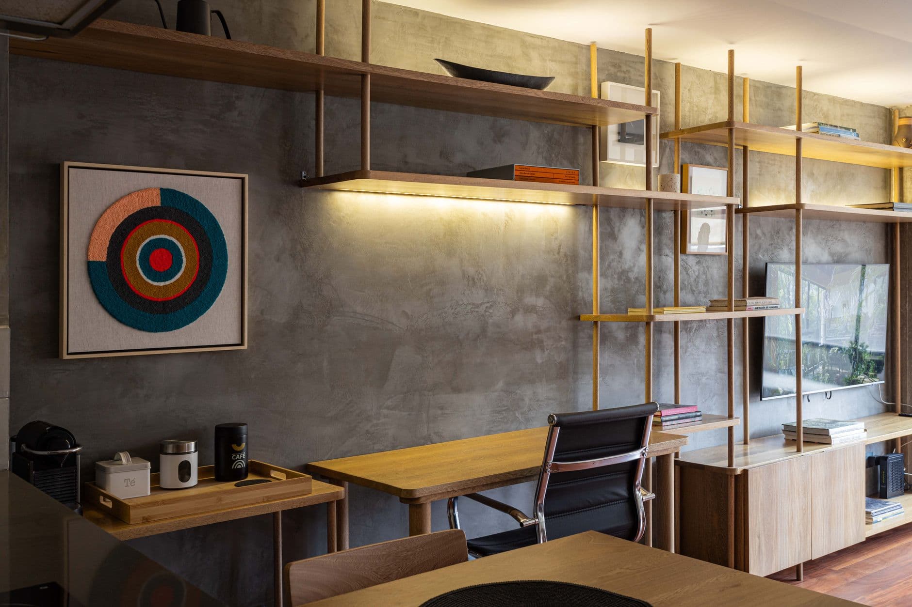 Contemporary interior design featuring wooden shelves, a desk, and modern decor.